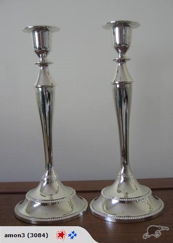 A SET OF TWO SINGLE SILVER CANDLE HOLDERS